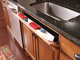 Tilt-out sink tray
